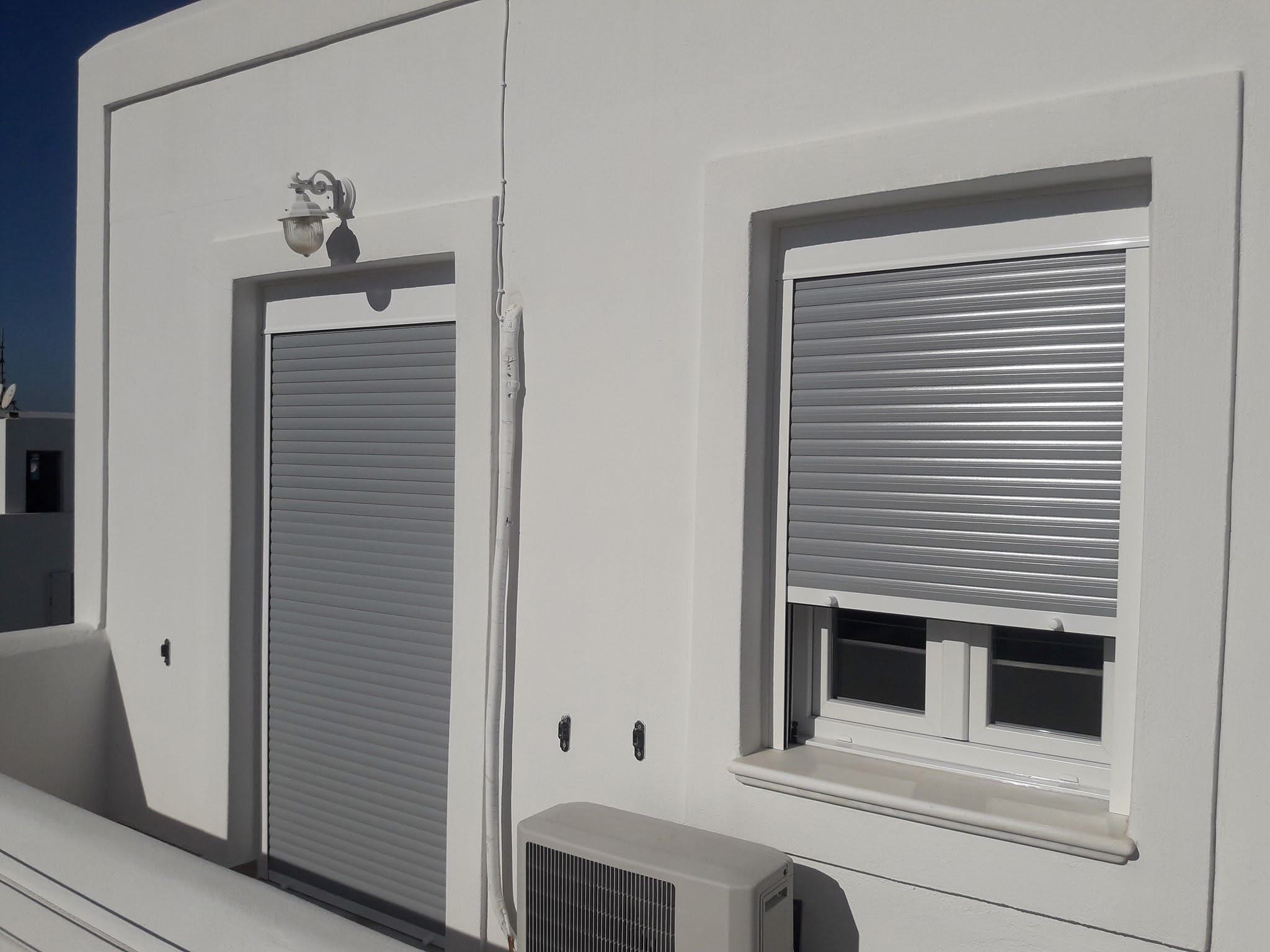 Roller shutters on a balcony door and window